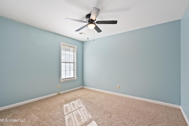 carpeted spare room with ceiling fan