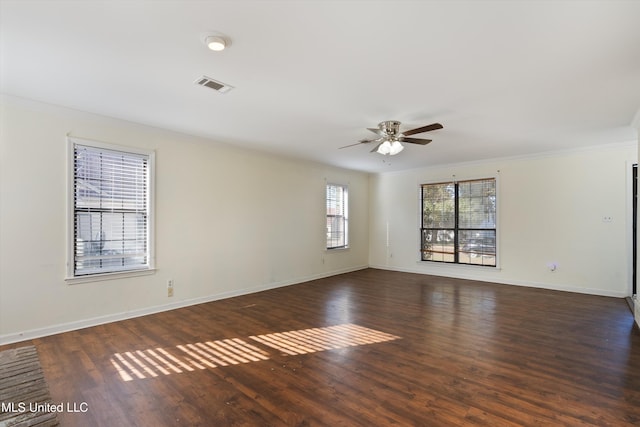 empty room featuring dark hardwood / wood-style floors, ceiling fan, and crown molding