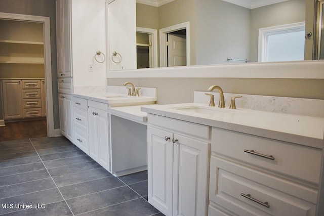 bathroom with tile patterned floors, vanity, and crown molding