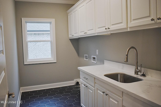 laundry area featuring cabinets, washer hookup, dark tile patterned flooring, and sink