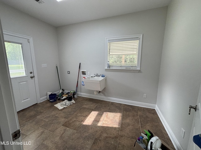 8 Jennie Ln, Picayune, MS 39466 - laundry area with hookup for a washing machine, baseboards, and dark stone finish floors