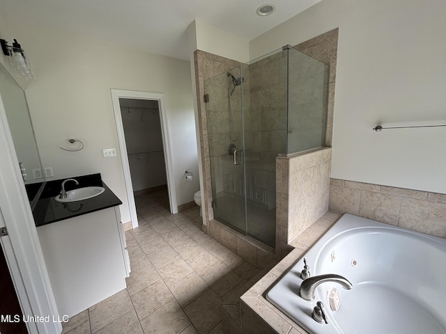 8 Jennie Ln, Picayune, MS 39466 - bathroom with a stall shower, vanity, toilet, a tub with jets, and a walk in closet