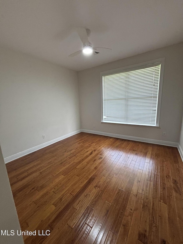 8 Jennie Ln, Picayune, MS 39466 - unfurnished room featuring dark wood-style flooring, ceiling fan, and baseboards