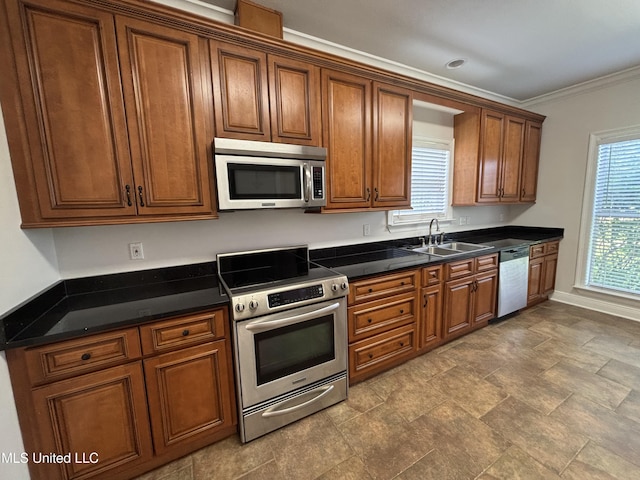8 Jennie Ln, Picayune, MS 39466 - kitchen with appliances with stainless steel finishes, a sink, brown cabinetry, baseboards, and ornamental molding