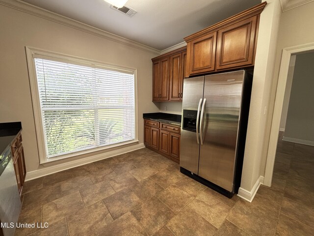 8 Jennie Ln, Picayune, MS 39466 - kitchen featuring appliances with stainless steel finishes, baseboards, dark countertops, crown molding, and brown cabinetry