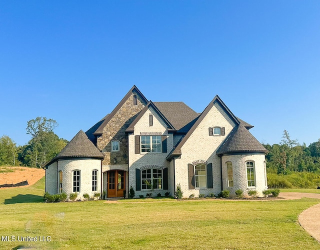 french provincial home featuring a front lawn