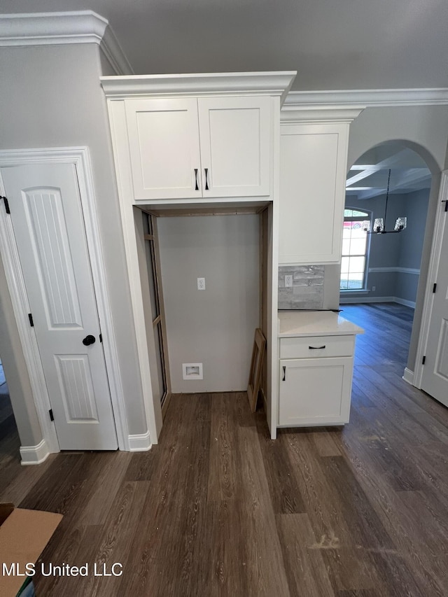 145 Poplar Ln, Holly Springs, MS 38635 - kitchen with arched walkways, dark wood-style floors, crown molding, white cabinets, and light countertops