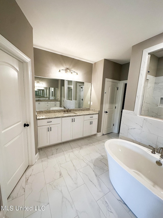 bathroom featuring separate shower and tub and vanity