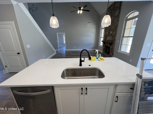 145 Poplar Ln, Holly Springs, MS 38635 - kitchen featuring a sink, stainless steel dishwasher, open floor plan, ceiling fan, and light stone counters