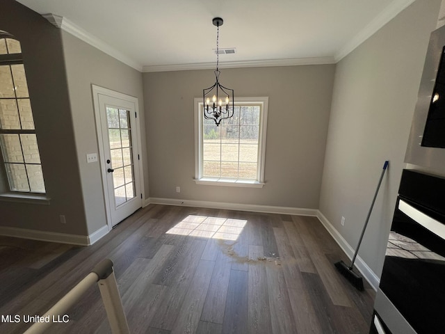 145 Poplar Ln, Holly Springs, MS 38635 - unfurnished dining area featuring dark wood-style floors, a chandelier, crown molding, and baseboards
