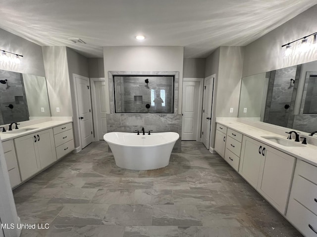 145 Poplar Ln, Holly Springs, MS 38635 - full bathroom with a walk in shower, two vanities, marble look tile flooring, and a freestanding bath