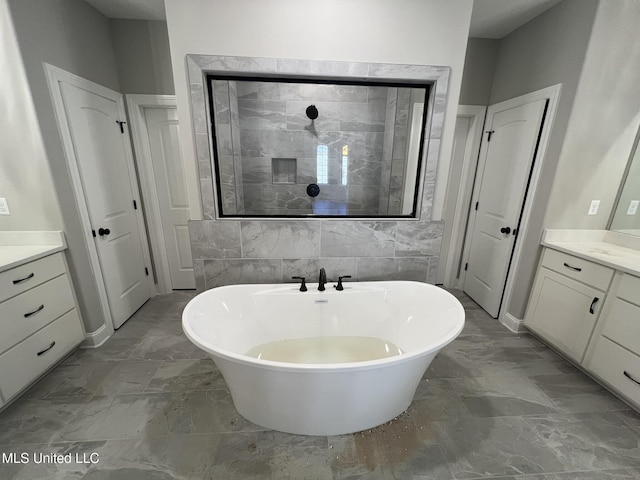 145 Poplar Ln, Holly Springs, MS 38635 - full bathroom with vanity, a freestanding tub, and marble finish floors