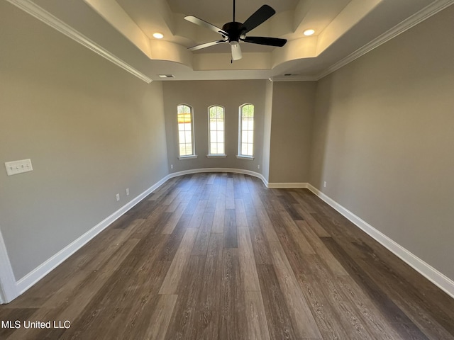 145 Poplar Ln, Holly Springs, MS 38635 - empty room featuring a ceiling fan, a tray ceiling, dark wood-type flooring, baseboards, and crown molding