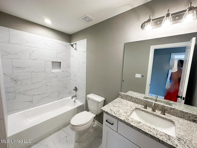 full bathroom featuring vanity, toilet, and tiled shower / bath