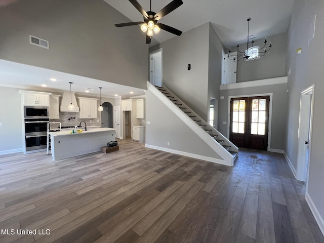 145 Poplar Ln, Holly Springs, MS 38635 - foyer entrance with a high ceiling, baseboards, a chandelier, ceiling fan, and french doors