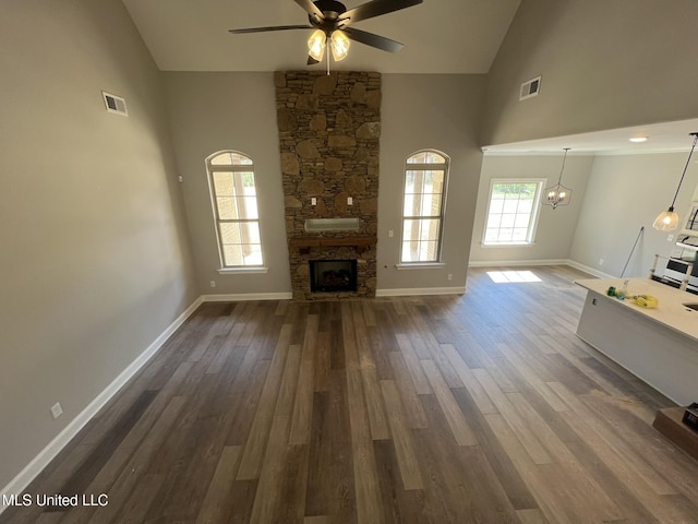 145 Poplar Ln, Holly Springs, MS 38635 - unfurnished living room featuring high vaulted ceiling, a ceiling fan, dark wood-style floors, baseboards, and a chandelier