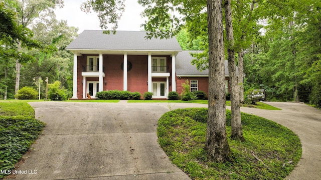 8855 Pine Springs Rd, Meridian, MS 39305 - neoclassical / greek revival house with french doors, curved driveway, and brick siding