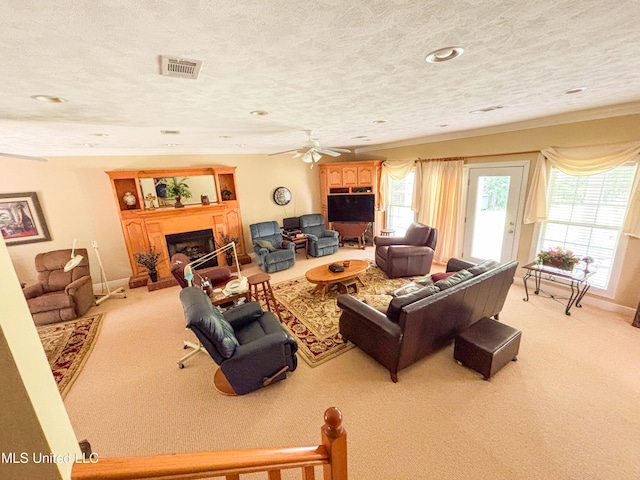 8855 Pine Springs Rd, Meridian, MS 39305 - living area featuring light colored carpet, a fireplace with raised hearth, ornamental molding, ceiling fan, and recessed lighting