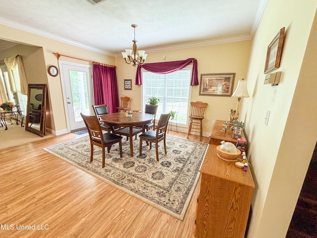 8855 Pine Springs Rd, Meridian, MS 39305 - dining space with light wood-type flooring, a chandelier, crown molding, and baseboards