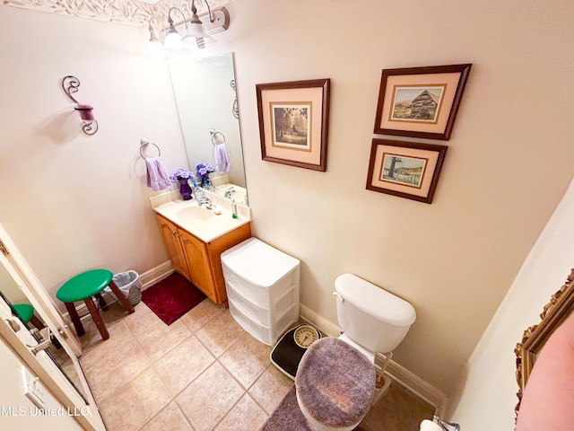 8855 Pine Springs Rd, Meridian, MS 39305 - bathroom featuring vanity, toilet, tile patterned flooring, and baseboards