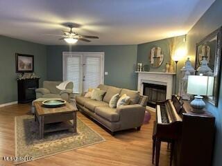 1124 Old Mobile Hwy, Lucedale, MS 39452 - living area featuring a fireplace, a ceiling fan, and wood finished floors