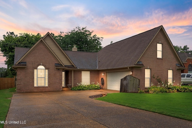 view of property with a yard and a garage