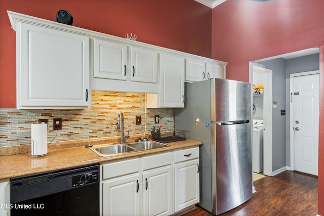 kitchen with black dishwasher, sink, stainless steel fridge, and white cabinets