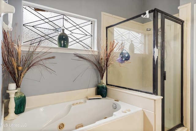 bathroom featuring separate shower and tub