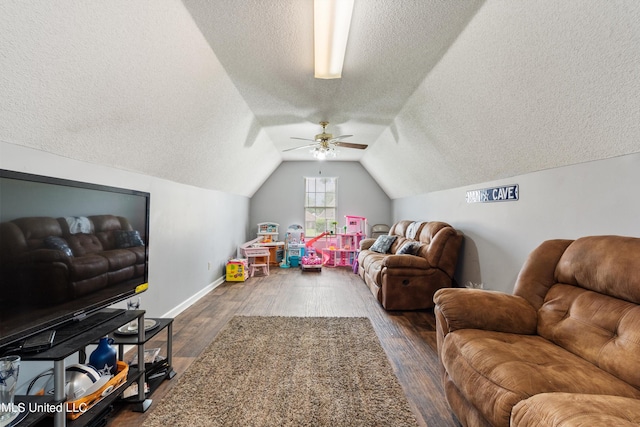 playroom featuring lofted ceiling, a textured ceiling, and dark hardwood / wood-style flooring