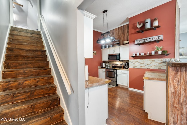 stairs with hardwood / wood-style flooring and ornamental molding