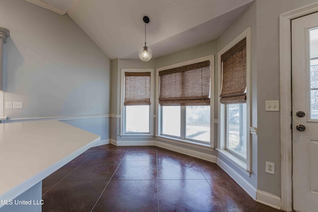 unfurnished dining area with vaulted ceiling