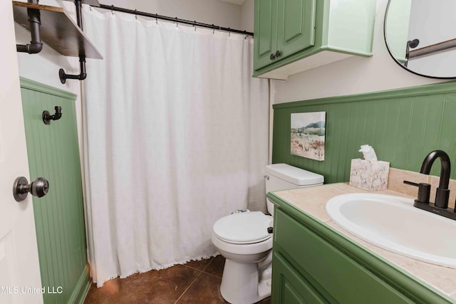 bathroom with vanity, toilet, and tile patterned flooring