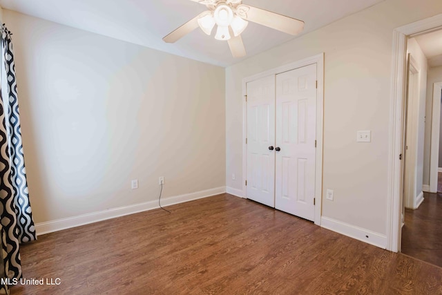 unfurnished bedroom with dark hardwood / wood-style floors, ceiling fan, and a closet