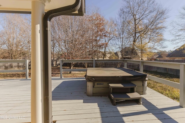 wooden deck featuring a hot tub