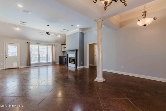 unfurnished living room with decorative columns, ornamental molding, dark tile patterned flooring, and ceiling fan