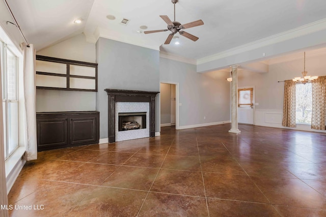 unfurnished living room featuring lofted ceiling, dark tile patterned floors, decorative columns, ornamental molding, and ceiling fan with notable chandelier