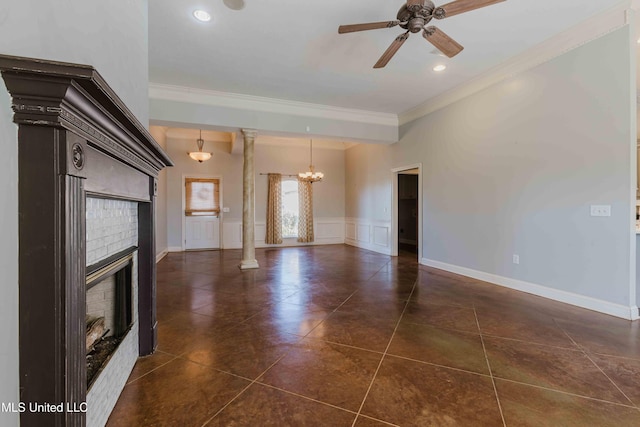 unfurnished living room with ornamental molding, a fireplace, decorative columns, and dark tile patterned floors