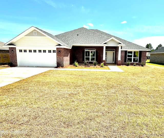 view of front of home with a front yard and a garage