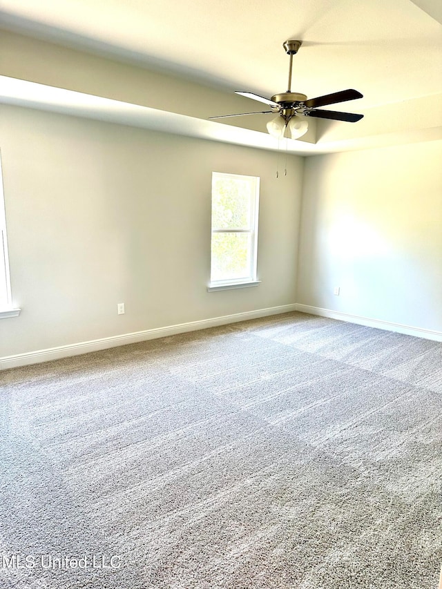 spare room with carpet and ceiling fan