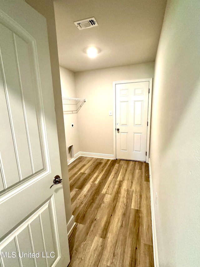 laundry area with electric dryer hookup and light wood-type flooring