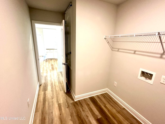 laundry room featuring washer hookup and light wood-type flooring