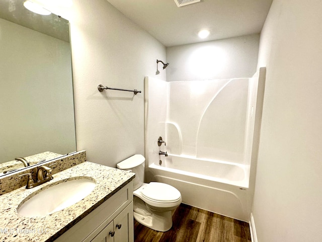 full bathroom with vanity, toilet, shower / bathing tub combination, and hardwood / wood-style flooring