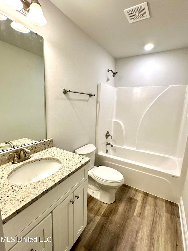 full bathroom with vanity, toilet, shower / bathing tub combination, and hardwood / wood-style flooring