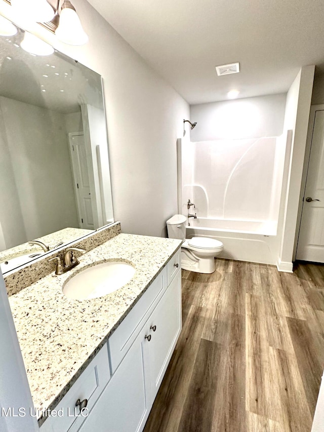 full bathroom featuring shower / bathing tub combination, vanity, toilet, and wood-type flooring