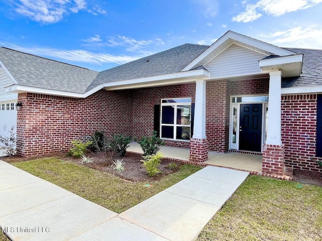 view of front of home with an attached garage, brick siding, and roof with shingles
