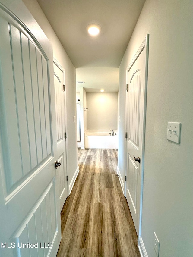 hallway featuring hardwood / wood-style floors