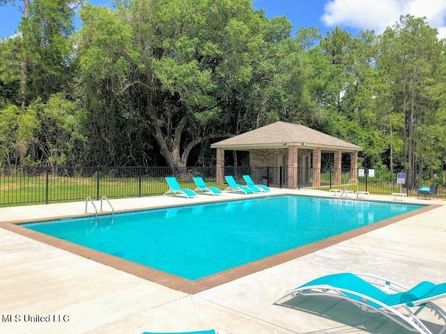 pool featuring a patio and fence