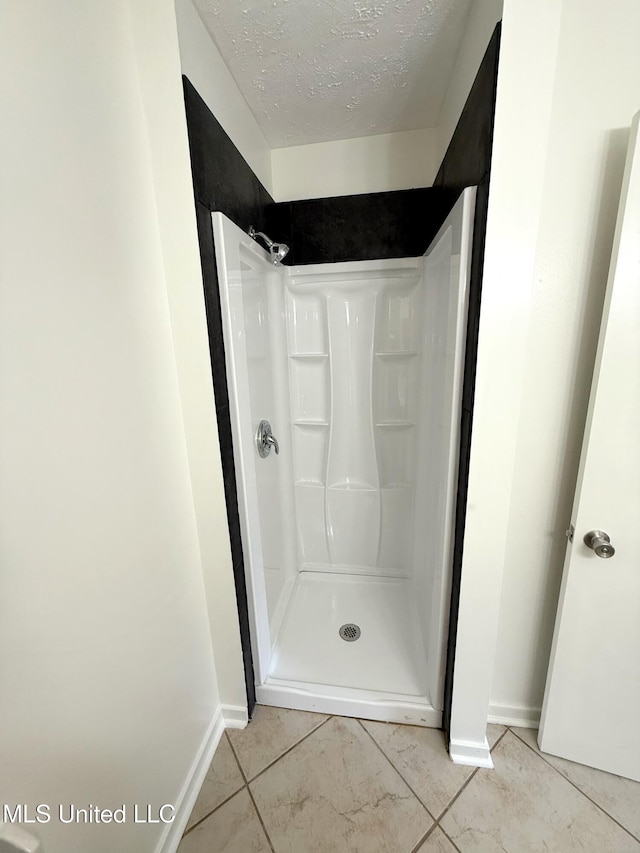 239 Traceland Dr, Madison, MS 39110 - bathroom with baseboards, a stall shower, and a textured ceiling