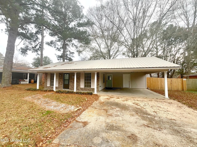 239 Traceland Dr, Madison, MS 39110 - ranch-style house with concrete driveway, an attached carport, metal roof, and covered porch