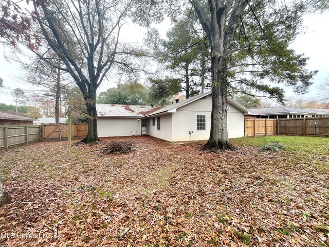 239 Traceland Dr, Madison, MS 39110 - back of property featuring a fenced backyard and a chimney